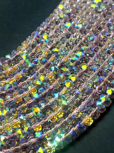 Light pink rainbow crystal glass beads. Chinese crystal rondelle shape 5x8mm. Great quality glass, full strand.