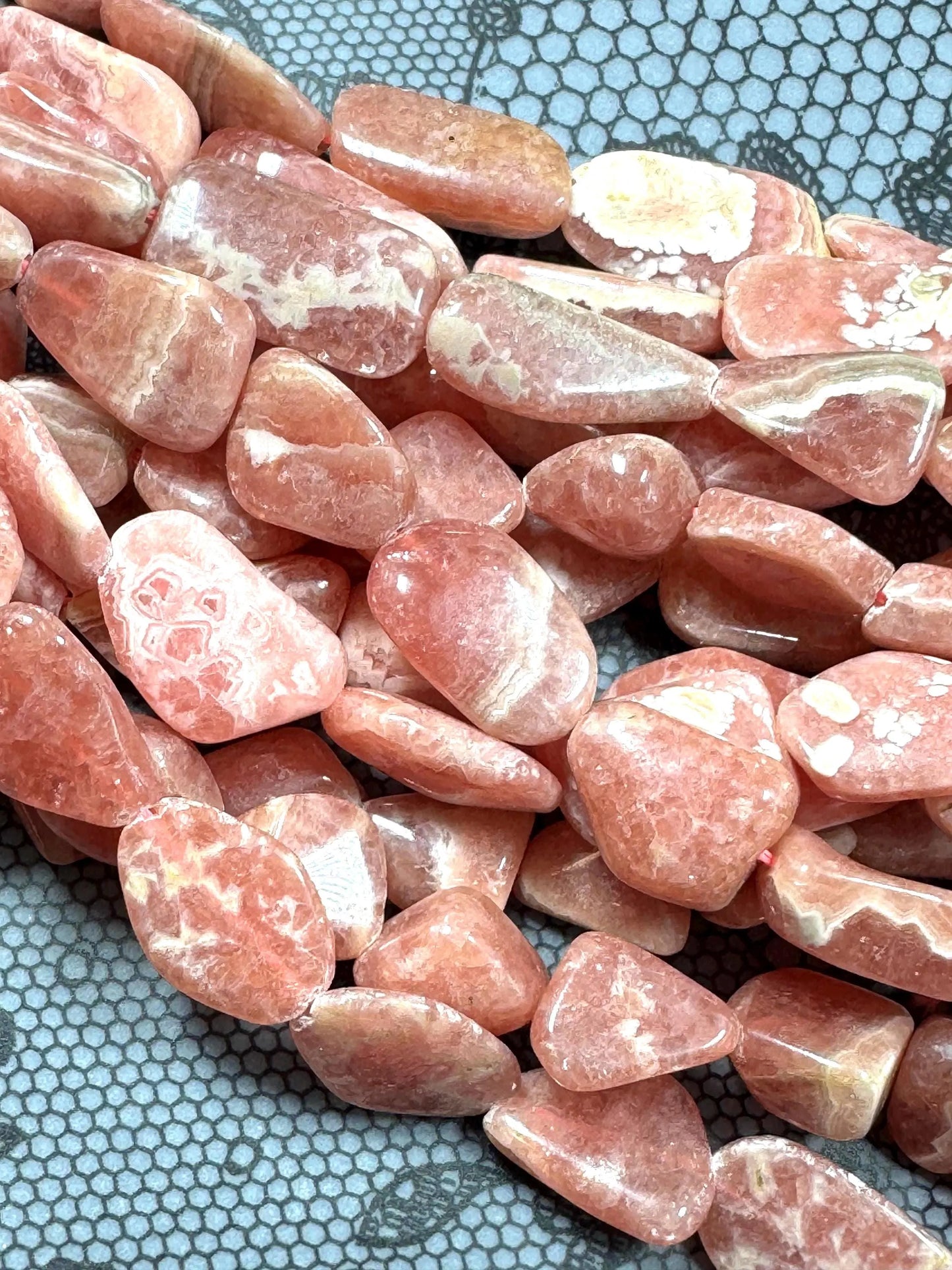 AA natural rhodochrosite stone bead. Gorgeous natural freedom nugget shape. natural pink color rhodochrosite expands quality full strand