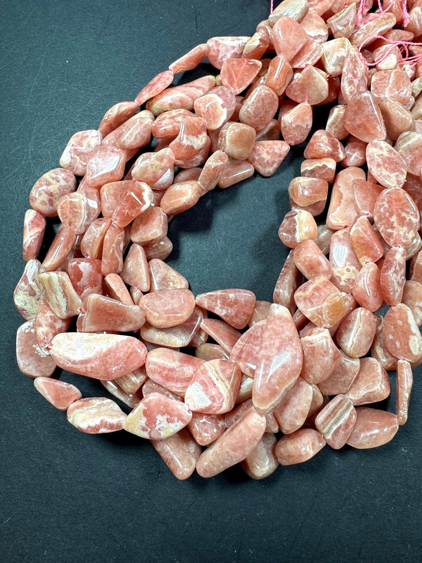 AA natural rhodochrosite stone bead. Gorgeous natural freedom nugget shape. natural pink color rhodochrosite expands quality full strand