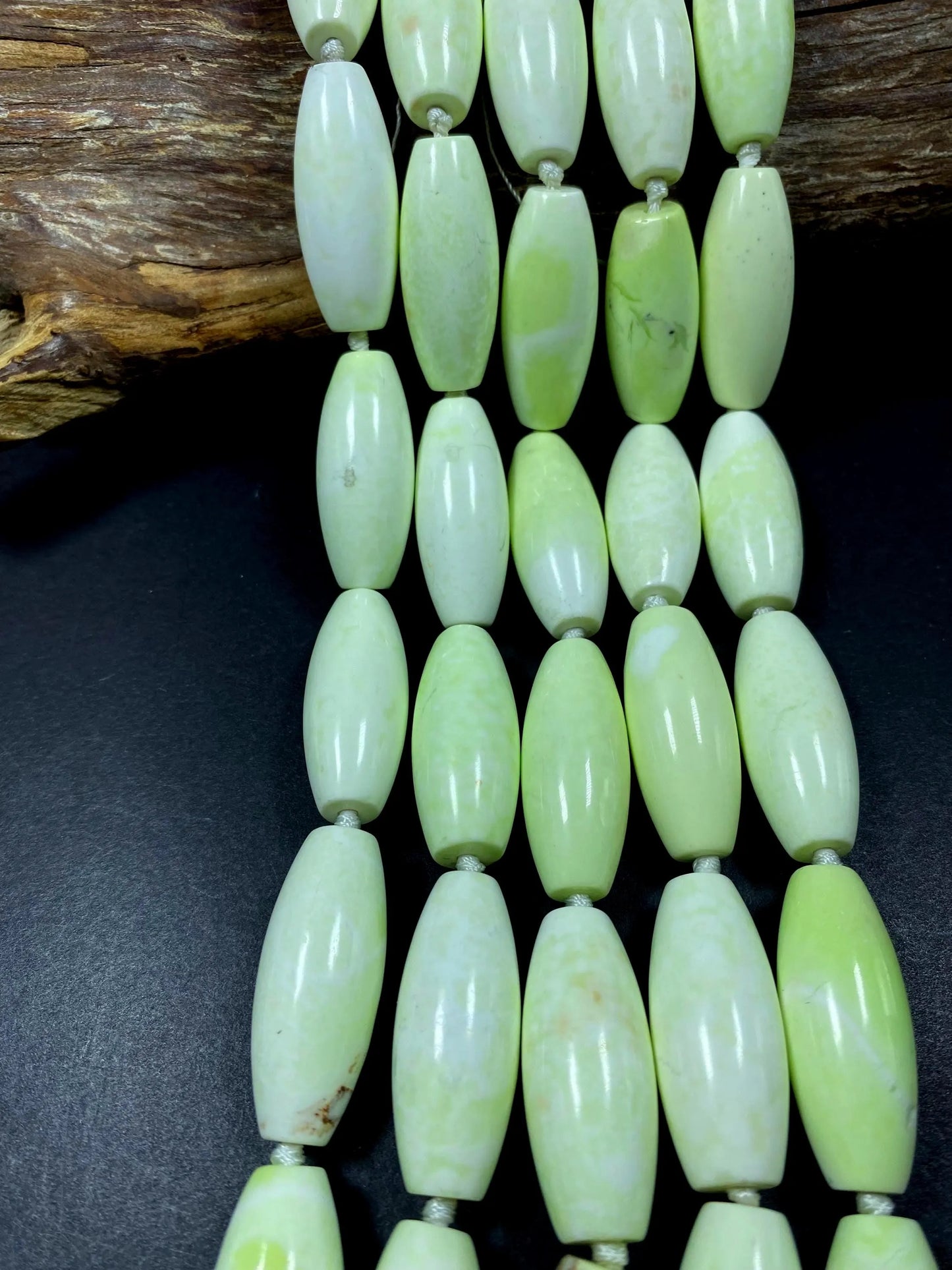 AAA natural Gaspeite bead. 16x39mm barrel shape. Gorgeous turquoise lemon color. High polished gemstone bead. Real nice quality!