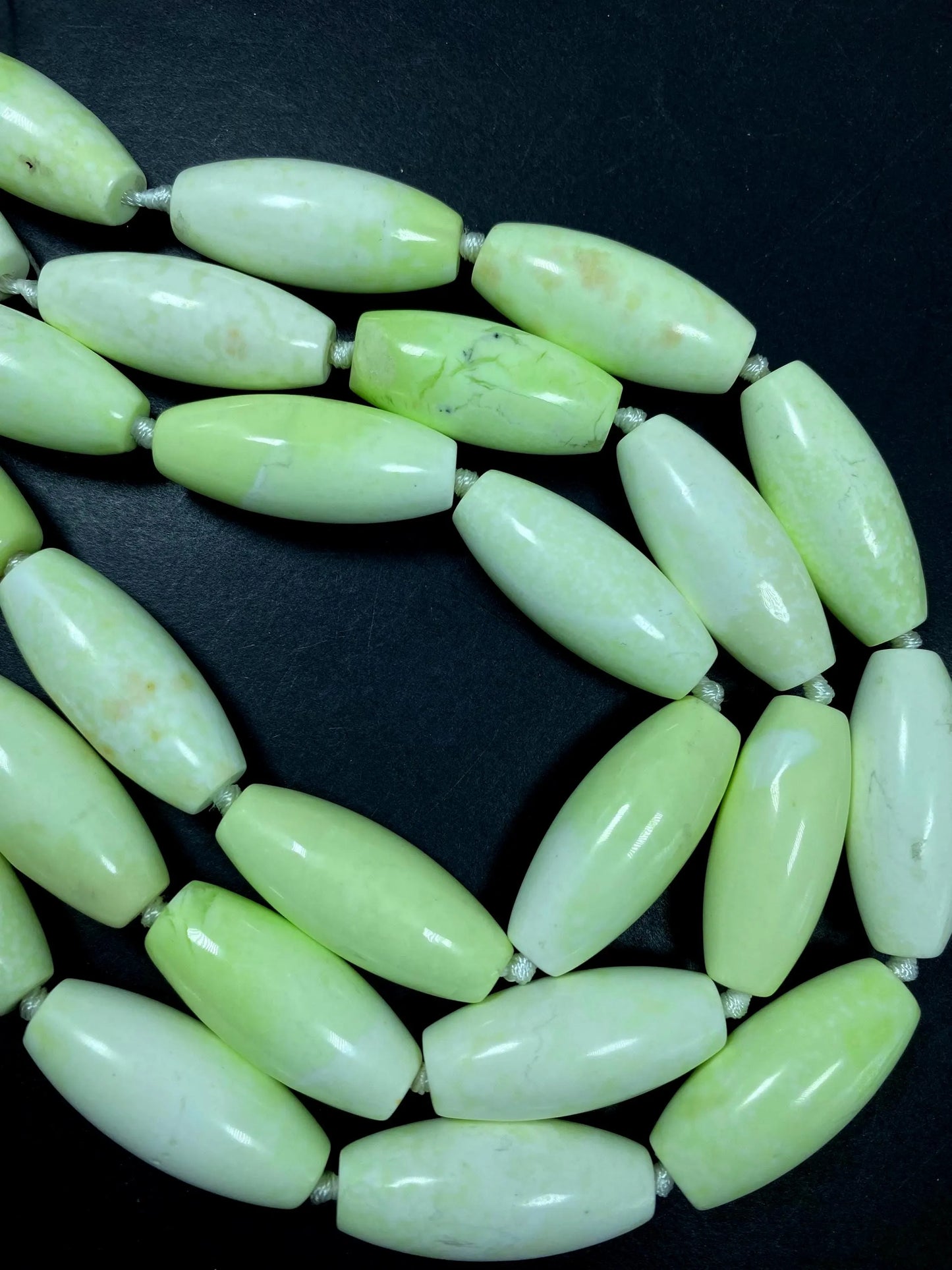 AAA natural Gaspeite bead. 16x39mm barrel shape. Gorgeous turquoise lemon color. High polished gemstone bead. Real nice quality!
