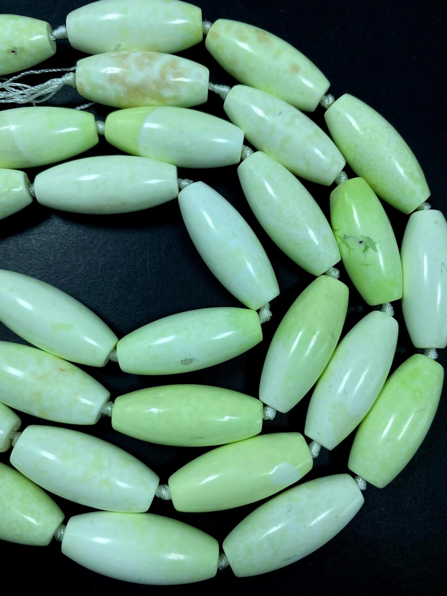 AAA natural Gaspeite bead. 16x39mm barrel shape. Gorgeous turquoise lemon color. High polished gemstone bead. Real nice quality!