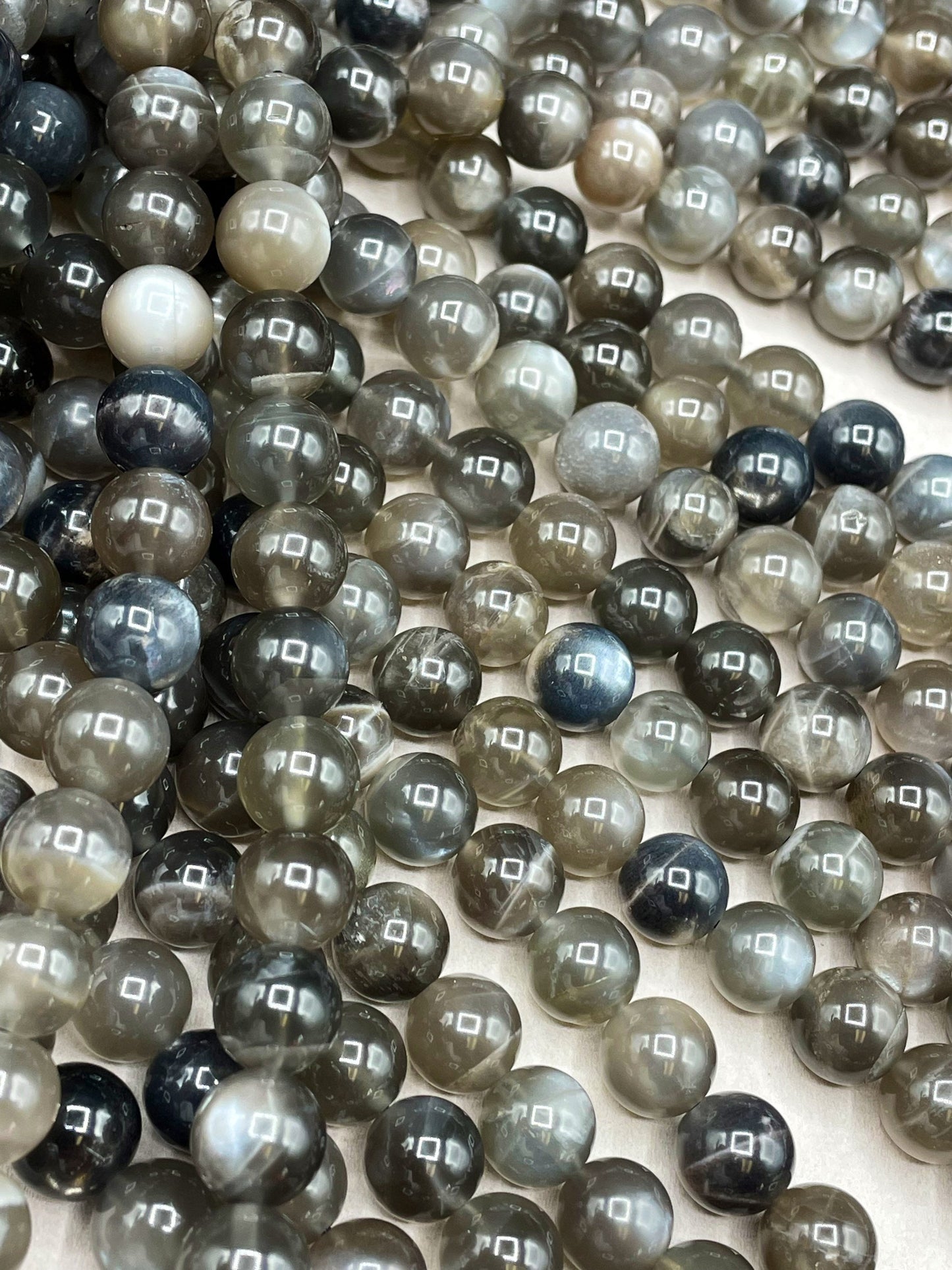 AAA Natural black rainbow moonstone .6mm 8mm 10mm round bead . Gorgeous natural black rainbow moonstone . Real nice quality. Full strand 15