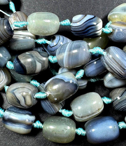 AAA Natural Botswana gemstone bead. Tuba shape. Beautiful Natural gray brown color. Not treated. Excellent quality. Full strand 15.5”