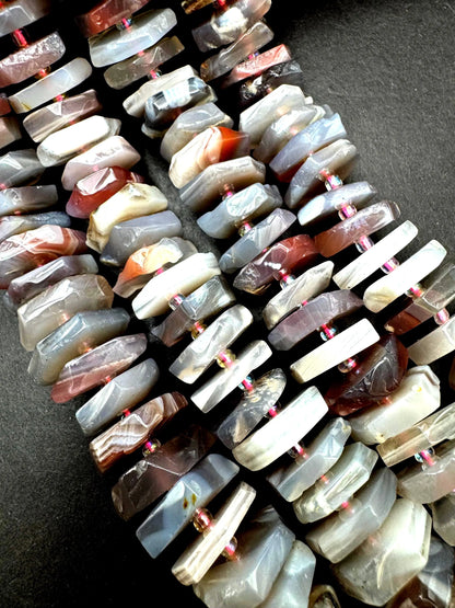 Natural Botswana gemstone bead. pinwheel shape . Gorgeous natural pink purple grayish color. Full strand 15.5”