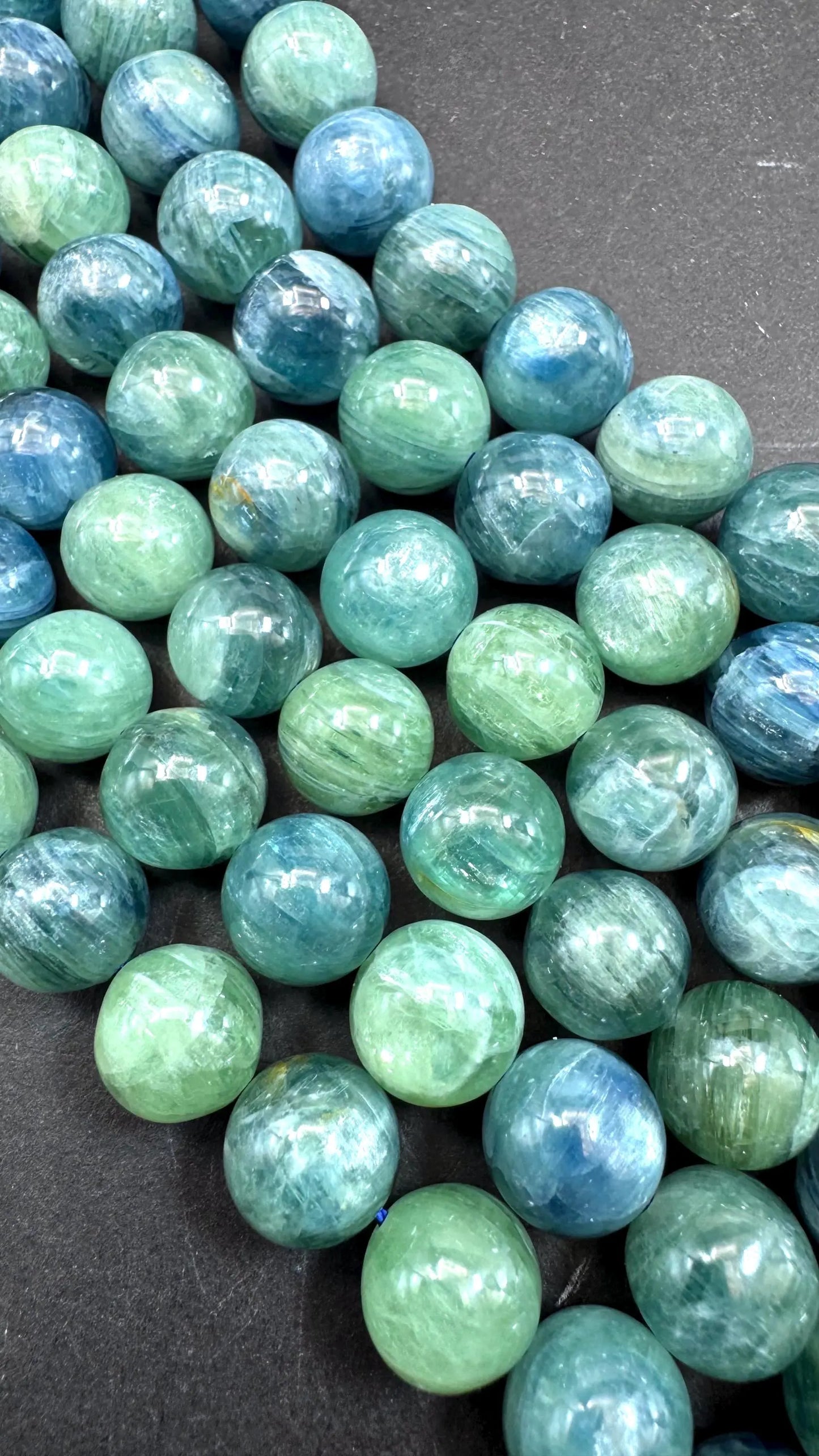 AAA Natural green kyanite gemstone bead. Smooth round bead. Gorgeous Natural green blue color . Excellent quality. Full strand 15.5”