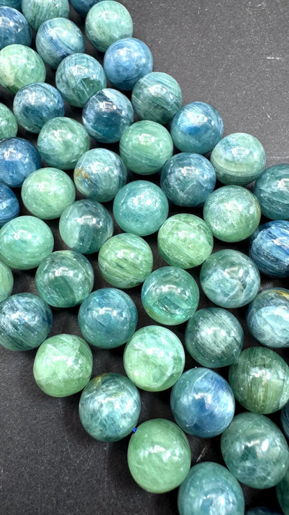 AAA Natural green kyanite gemstone bead. Smooth round bead. Gorgeous Natural green blue color . Excellent quality. Full strand 15.5”