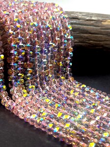 Light pink rainbow crystal glass beads. Chinese crystal rondelle shape 5x8mm. Great quality glass, full strand.