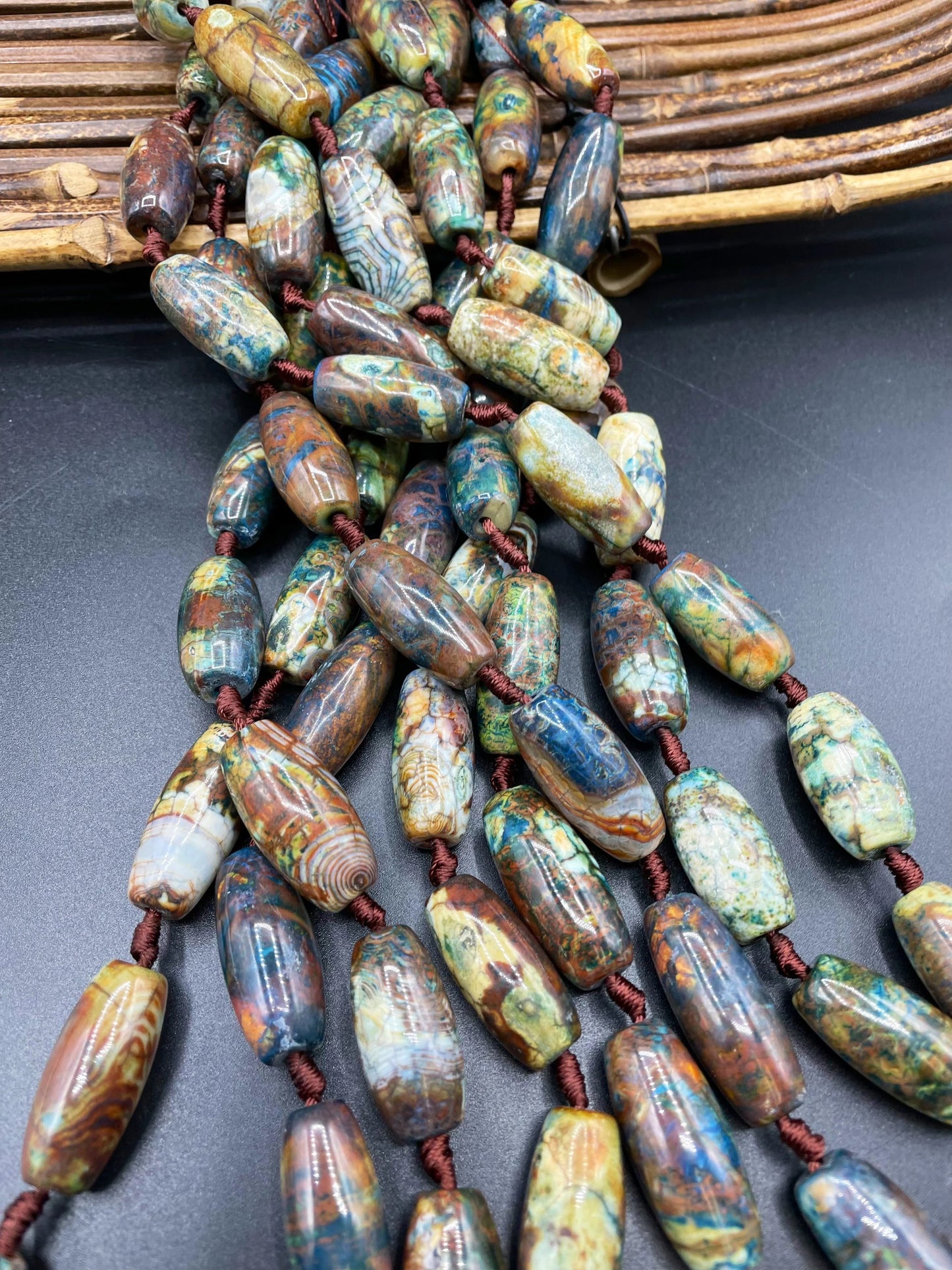 Beautiful natural Tibetan gemstone bead. 12x40mm barrel shape. Beautiful brown blue orange color gemstone. Full strand 15.5”