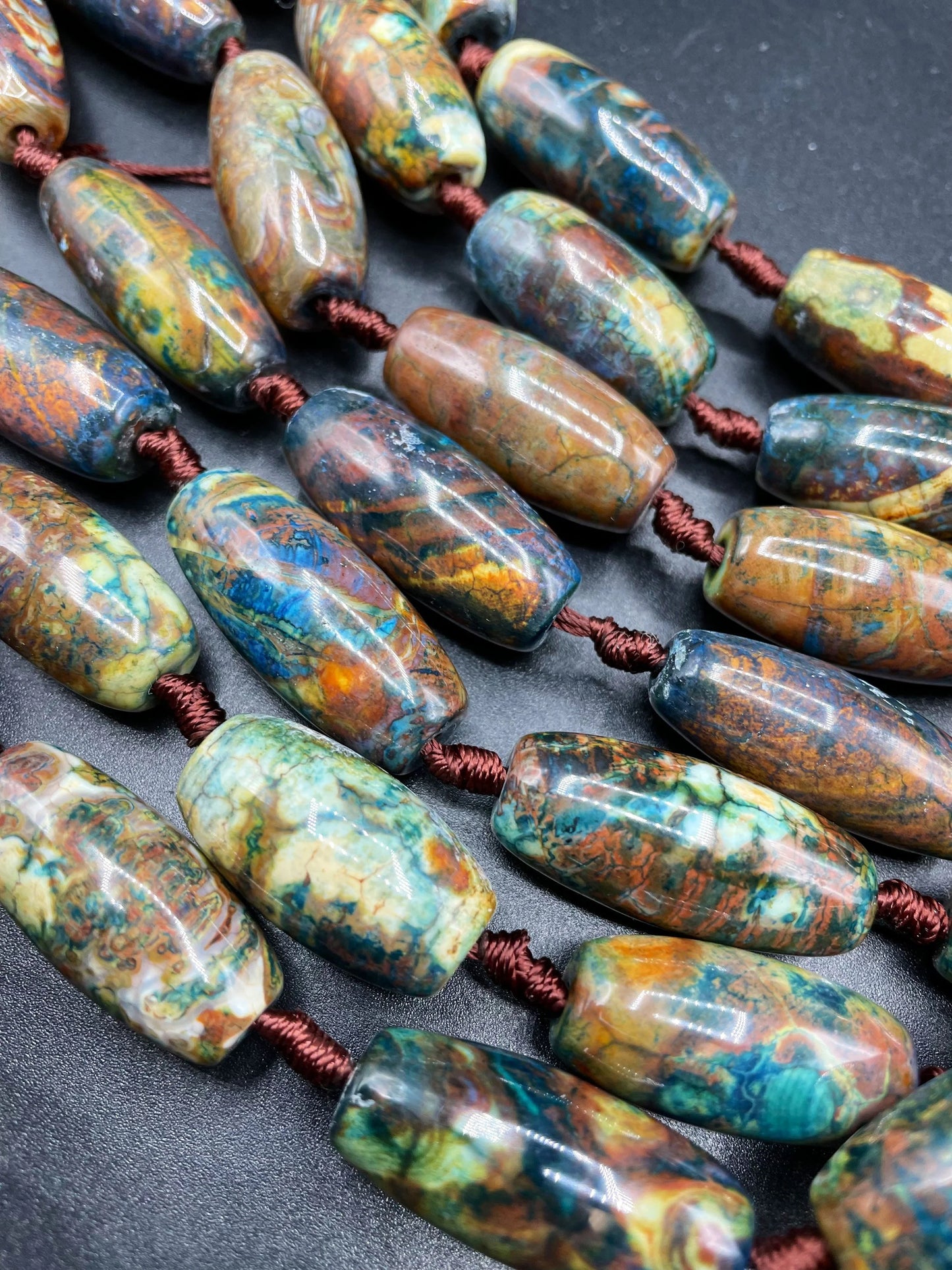 Beautiful natural Tibetan gemstone bead. 12x40mm barrel shape. Beautiful brown blue orange color gemstone. Full strand 15.5”