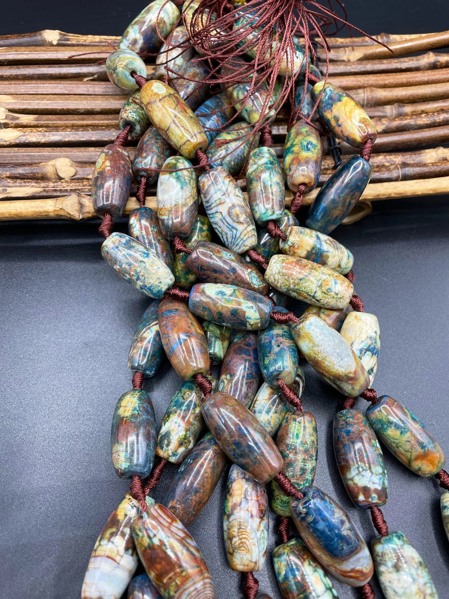 Beautiful natural Tibetan gemstone bead. 12x40mm barrel shape. Beautiful brown blue orange color gemstone. Full strand 15.5”