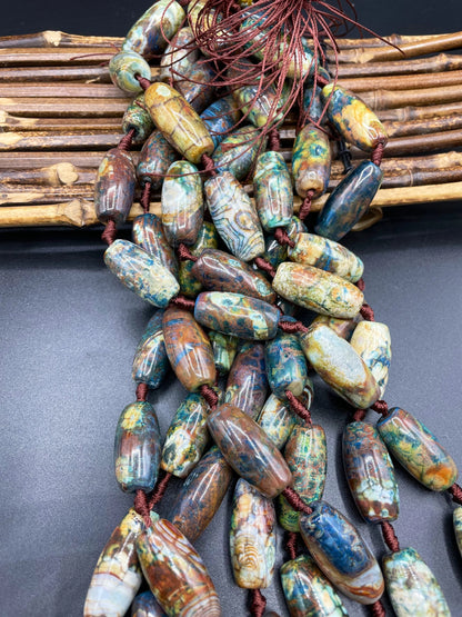 Beautiful natural Tibetan gemstone bead. 12x40mm barrel shape. Beautiful brown blue orange color gemstone. Full strand 15.5”