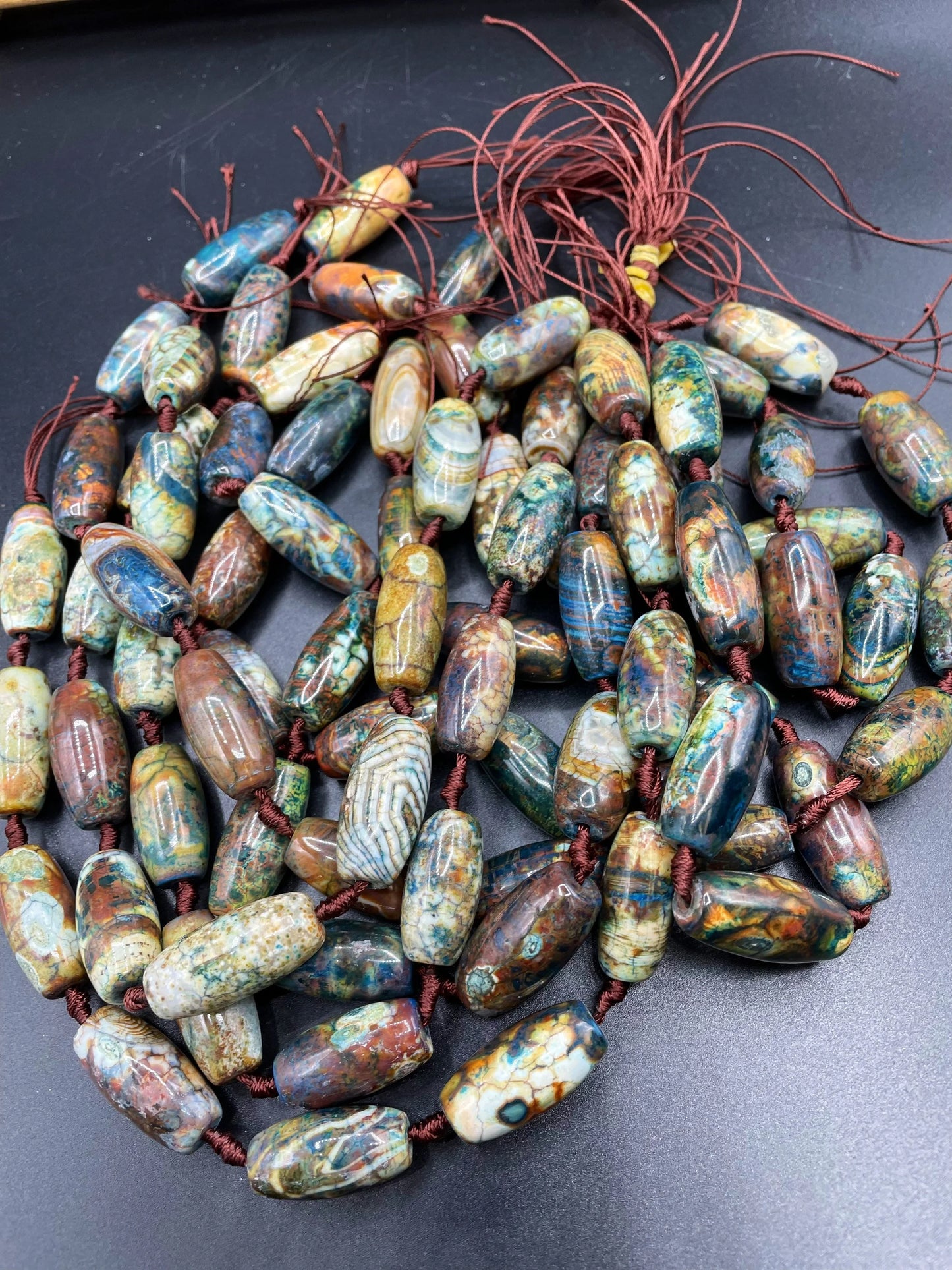 Beautiful natural Tibetan gemstone bead. 12x40mm barrel shape. Beautiful brown blue orange color gemstone. Full strand 15.5”
