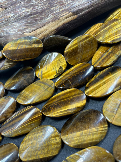 AAA Natural tiger eye smooth oval stone bead . .Gorgeous golden brown color tiger eye . Great quality gemstone . 15.5” 44x24mm