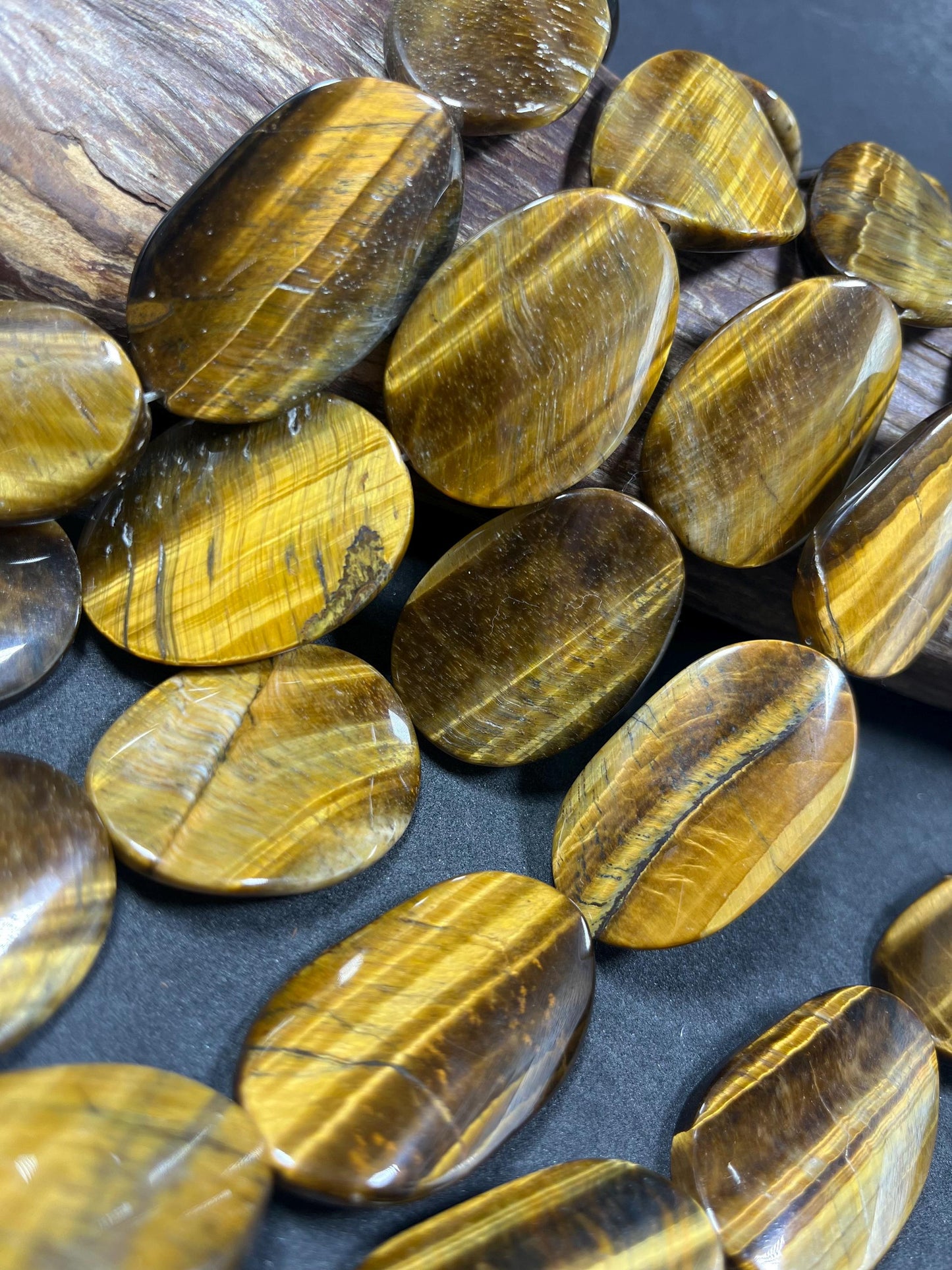 AAA Natural tiger eye smooth oval stone bead . .Gorgeous golden brown color tiger eye . Great quality gemstone . 15.5” 44x24mm