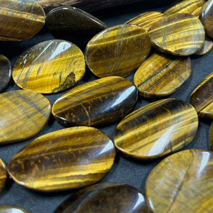AAA Natural tiger eye smooth oval stone bead . .Gorgeous golden brown color tiger eye . Great quality gemstone . 15.5” 44x24mm