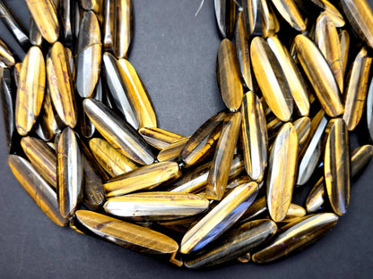 AAA Natural tiger eye faceted oval strips stone bead . .Gorgeous golden brown color tiger eye . Great quality gemstone . 15.5” 14x50mm