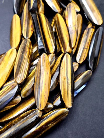 AAA Natural tiger eye faceted oval strips stone bead . .Gorgeous golden brown color tiger eye . Great quality gemstone . 15.5” 14x50mm