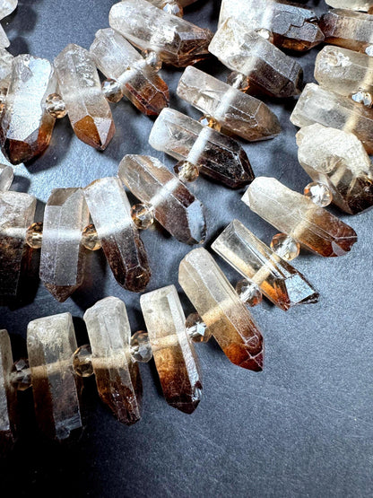 100% Natural Rock Crystal Quartz. Freedom Teeth Shape. Clear Brown Color. Full Strand 15.5"