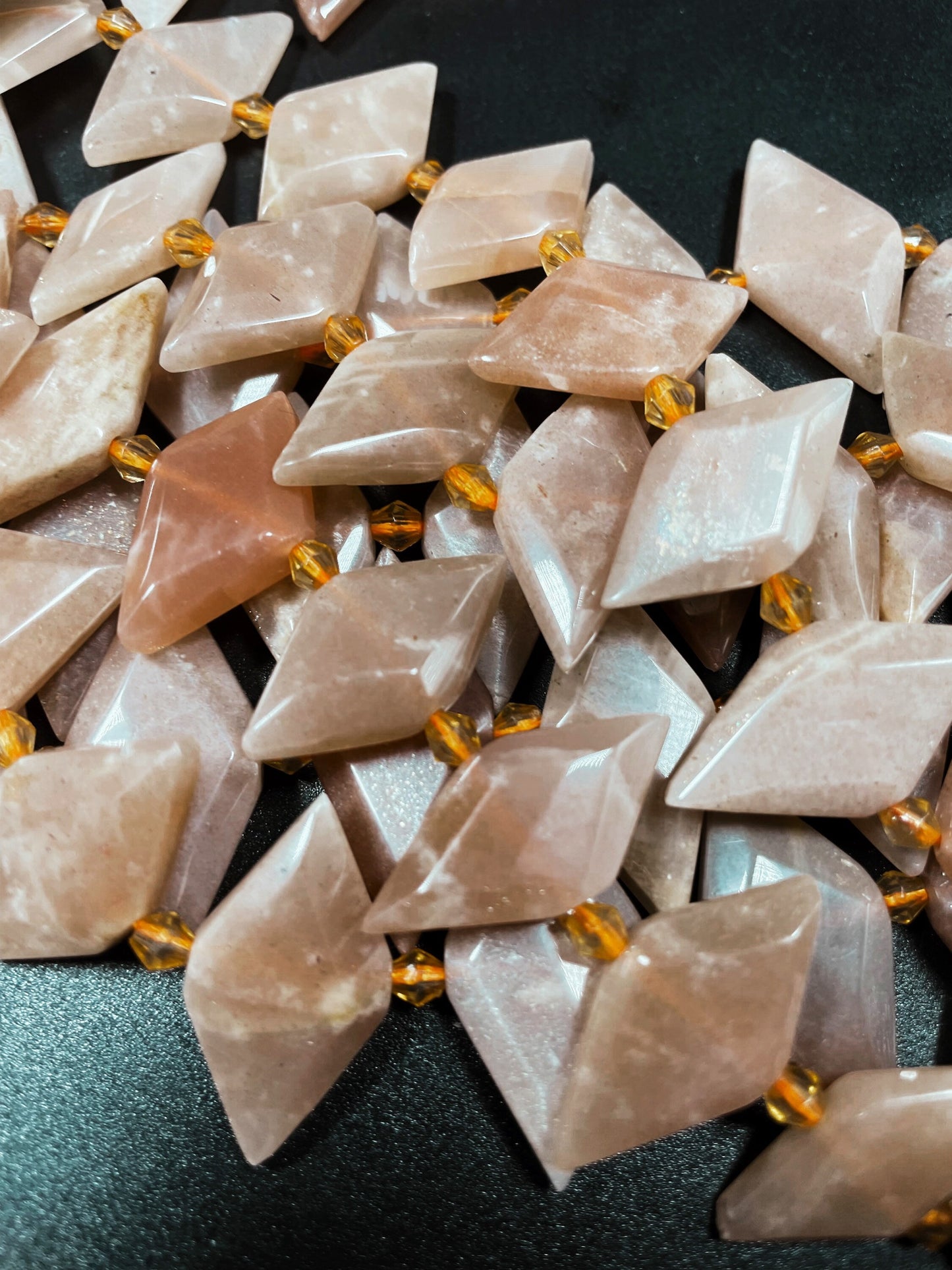 AAA natural peach moonstone bead.faceted 16x28mm diamond shape. Natural orange peach color moonstone bead. Full strand length 15.5”